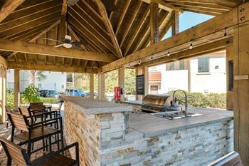 Outdoor grilling pavilion with bar counter seating 